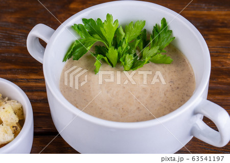 Mushroom cream soup with grenice and greens 63541197