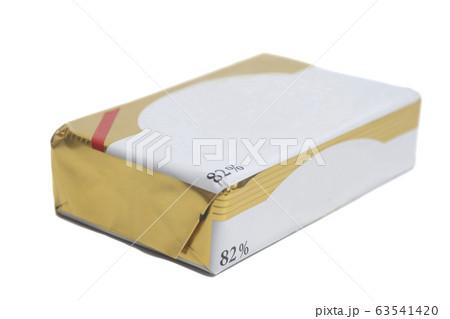 Stick of wrapped butter isolated on white Stick of wrapped butter isolated on white 63541420