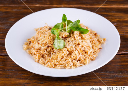 Boiled rice, served with greens and seasonings 63542127