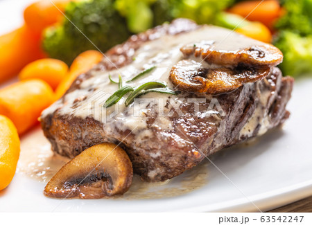 Juicy Beef Rib Eye Steak with mushroom sauce and Juicy Beef Rib Eye Steak with mushroom sauce and 63542247