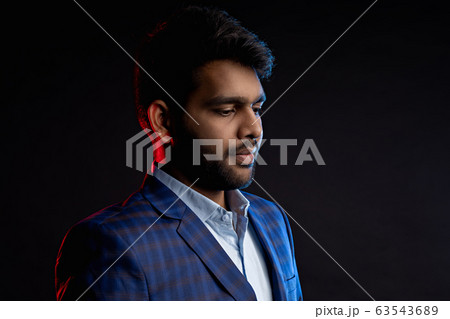 Indian young businessman on dark background 63543689