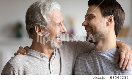 Happy mature dad hug show love to adult son Happy mature dad hug show love to adult son 63546252