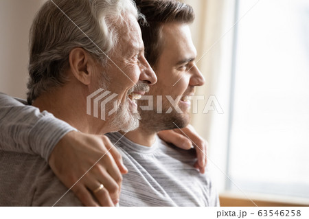 Elderly father and adult song look in distance dreaming Elderly father and adult song look in distance dreaming 63546258