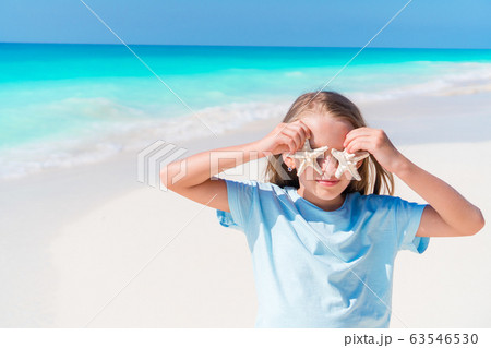 Cute little girl at beach during summer vacation Cute little girl at beach during summer vacation 63546530