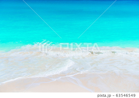Idyllic tropical beach with white sand, turquoise ocean water and blue sky on Caribbean island 63546549