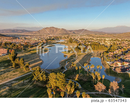 Aerial view of golf course surrounded by town houses and luxury villas during sunset time, Temecula 63547343