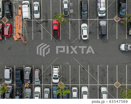 Aerial top view of parking lot at supermarket with with varieties of colored vehicles.  63547569