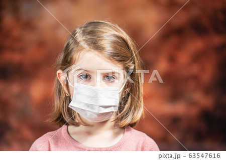 Coronovirus Quarantine, Stay Home Concept. Covid-19 pandemic. Little girl Wearing Surgical Mask. Coronovirus Quarantine, Stay Home Concept. Covid-19 pandemic. Little girl Wearing Surgical Mask. 63547616