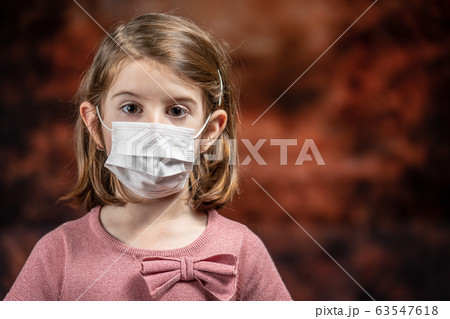 Coronovirus Quarantine, Stay Home Concept. Covid-19 pandemic. Little girl Wearing Surgical Mask. Coronovirus Quarantine, Stay Home Concept. Covid-19 pandemic. Little girl Wearing Surgical Mask. 63547618
