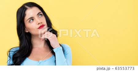 Young woman in a thoughtful pose 63553773