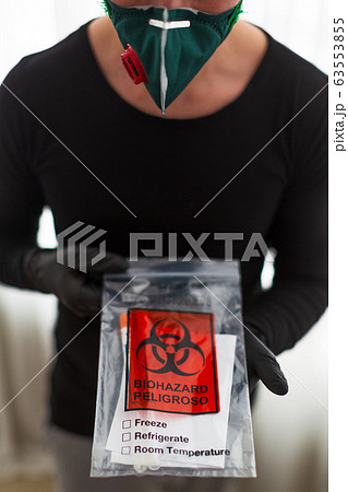 man in a protective mask holds a test 63553855