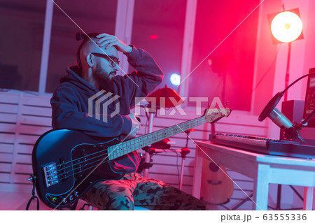 Musician and making music concept - Male sound producer working in recording studio. 63555336