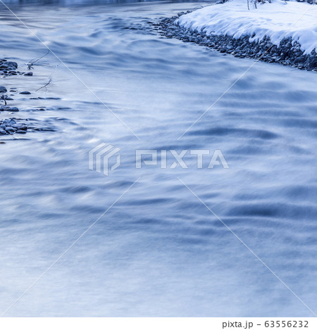 Long exposure of river in winter 63556232