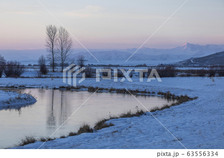 Snow by a stream at sunset in Picabo, Idaho 63556334
