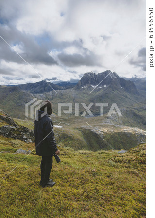 Young man hiking on mountain in Norway 63556550