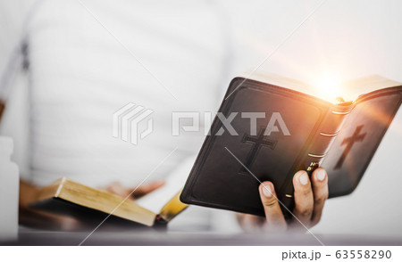 Young man with bible while reading, believe 63558290