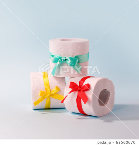 Set of toilet paper wrapped in a gift bow. The 63560670