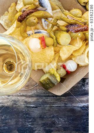 Tapas, top view. Wine and gildas, spicy pinchos, on potato chips with copy space 63562286