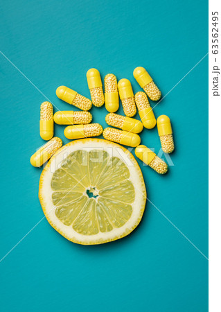Vitamin capsules. Vitamin C pills and slice of Vitamin capsules. Vitamin C pills and slice of 63562495