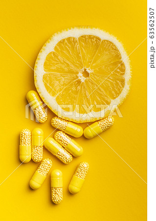 Vitamin capsules. Vitamin C pills and slice of Vitamin capsules. Vitamin C pills and slice of 63562507