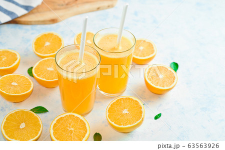 orange juice in a glass, top view, slices of oranges, straw, healthy lifestyle concept orange juice in a glass, top view, slices of oranges, straw, healthy lifestyle concept 63563926