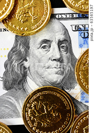 close up of gold coins on banknote  63565197