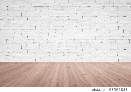 Grunge old aged brick wall painted in white color with wooden floor textured background in red brown Grunge old aged brick wall painted in white color with wooden floor textured background in red brown 63565883