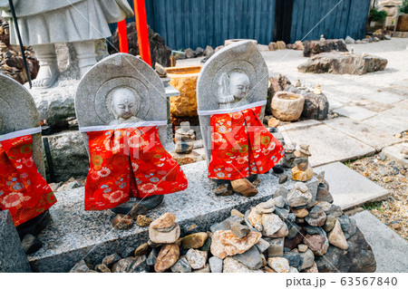 Buddha statue wearing red apron in Kyoto, Japan Buddha statue wearing red apron in Kyoto, Japan 63567840