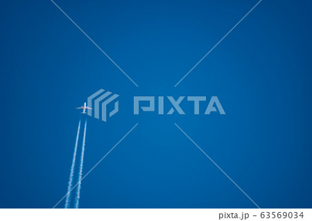 Jet plane trail crossing the sky from bottom left to upper side 63569034