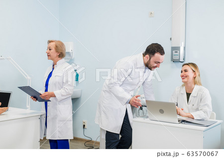 A group of scientists conducts research in a scientific laboratory using advanced technology. COVID-19. COVID Coronavirus 63570067