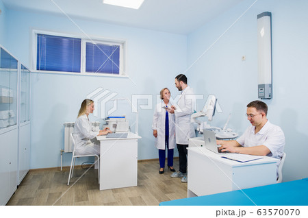 A group of scientists conducts research in a scientific laboratory using advanced technology. COVID-19. COVID Coronavirus 63570070