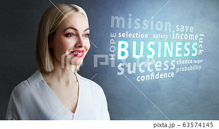 Adult blonde businesswoman looks on the cloud with tag words. Adult blonde businesswoman looks on the cloud with tag words. 63574145