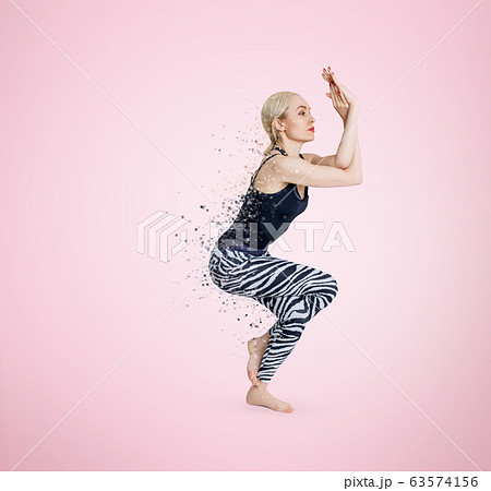 Woman in yoga posture decay on particles. Dispersion effect. Woman in yoga posture decay on particles. Dispersion effect. 63574156