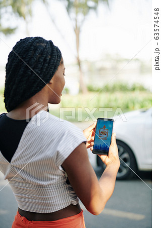 Woman using car sharing application 63574548