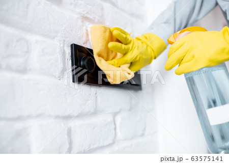 Woman cleaning stair railings at home Woman cleaning stair railings at home 63575141