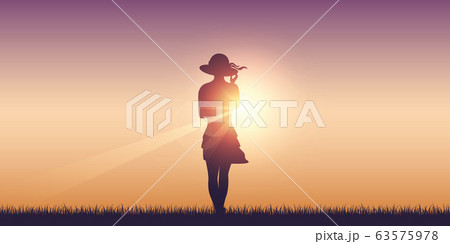 pretty girl with summer hat on meadow at sunshine 63575978