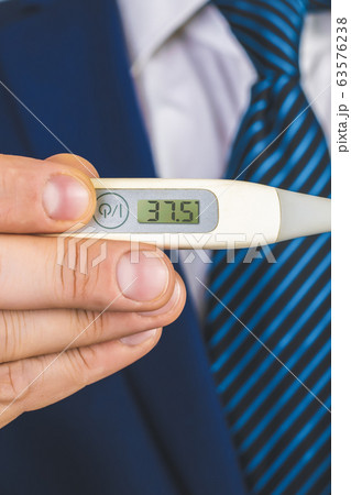 A man in a suit and tie holds in his hands an 63576238