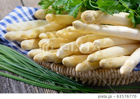 Fresh white asparagus from Germany with parsley and chives 63576770