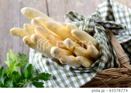 Fresh white asparagus from Germany with parsley 63576774
