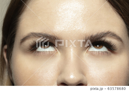 Close up of face of beautiful caucasian young woman, focus on eyes Close up of face of beautiful caucasian young woman, focus on eyes 63578680