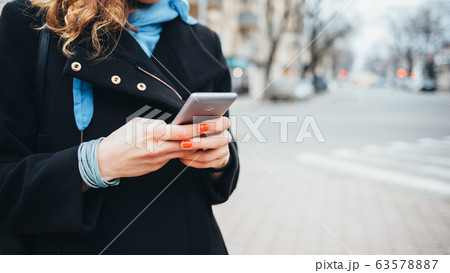 Young woman using mobile phone Young woman using mobile phone 63578887