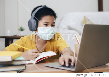 Boy wearing face masks online study at home. Boy wearing face masks online study at home. 63581070