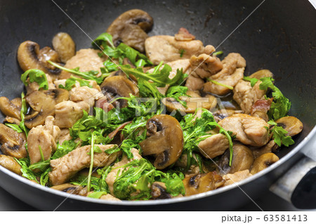 turkey meat with mushrooms and rocket in frying turkey meat with mushrooms and rocket in frying 63581413