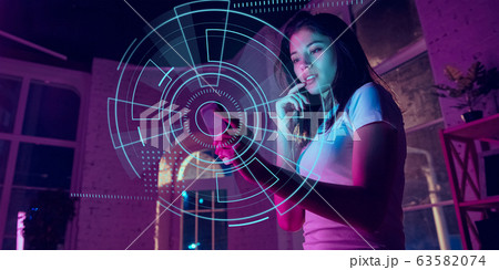 Woman using interface modern technology and digital layer effect as business, finance, economics strategy concept 63582074