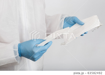 Doctor hand with some medical face mask for protection 63582492