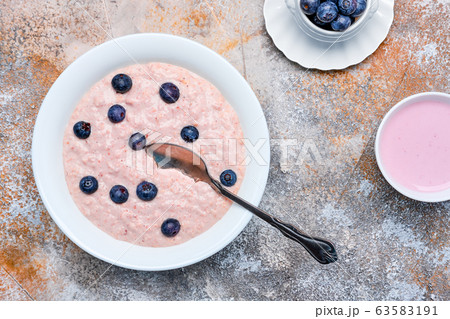 Top view of oatmeal with homemade blueberry yogurt Top view of oatmeal with homemade blueberry yogurt 63583191