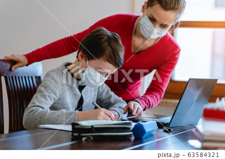 School student learning in video chat with teacher in e-learning 63584321