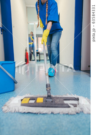 Close-up of cleaners moping the floor Close-up of cleaners moping the floor 63584331