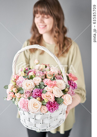 Small flower shop and Flowers delivery. Flower arrangement in Wicker basket. Beautiful bouquet of mixed flowers in woman hand. Handsome fresh bouquet. Small flower shop and Flowers delivery. Flower arrangement in Wicker basket. Beautiful bouquet of mixed flowers in woman hand. Handsome fresh bouquet. 63585709