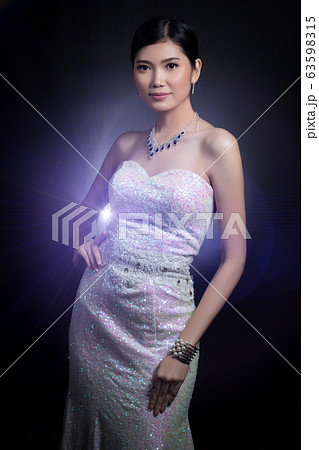 Evening Gown Ball Dress in Asian beautiful woman with fashion make up face eyes love heart black hair, studio lighting black background copy space. Concept luxury to join social night event Evening Gown Ball Dress in Asian beautiful woman with fashion make up face eyes love heart black hair, studio lighting black background copy space. Concept luxury to join social night event 63598315